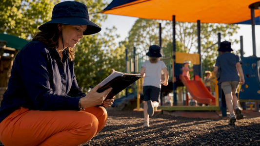 School nurse reviewing sun safety at playground