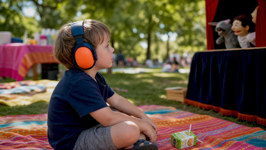 Child wearing noise protection earmuffs at festival