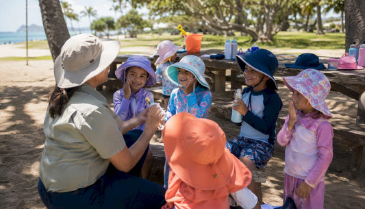 Children with sun hats and sunscreen outdoors